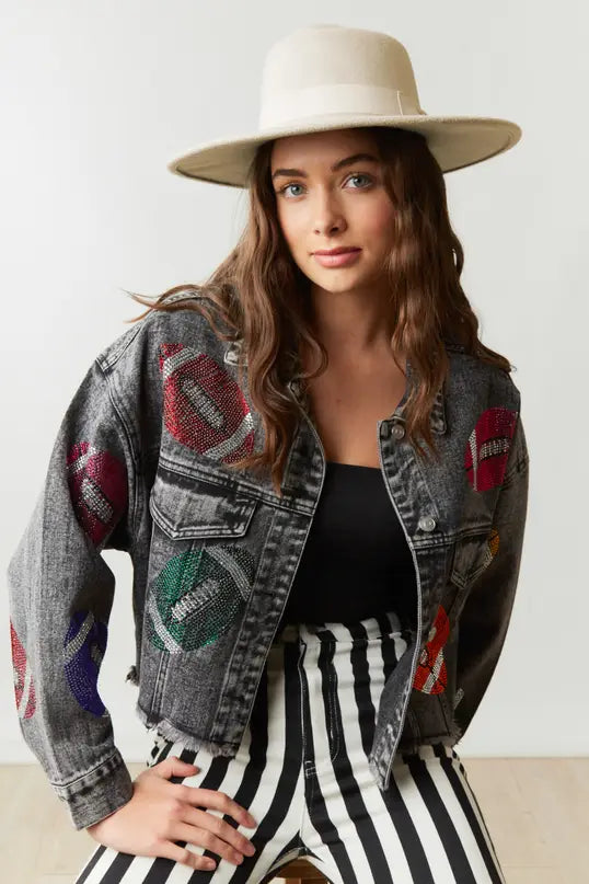 Elevate your game day style in our Game Day Jacket, a dazzling expression of team spirit. Rhinestone patches dazzle & catch the light, button-down closure ensures fit & layers. Pockets store essentials. Raw hem, cropped length adds edgy style. Perfect for a confident, fashion-forward look.