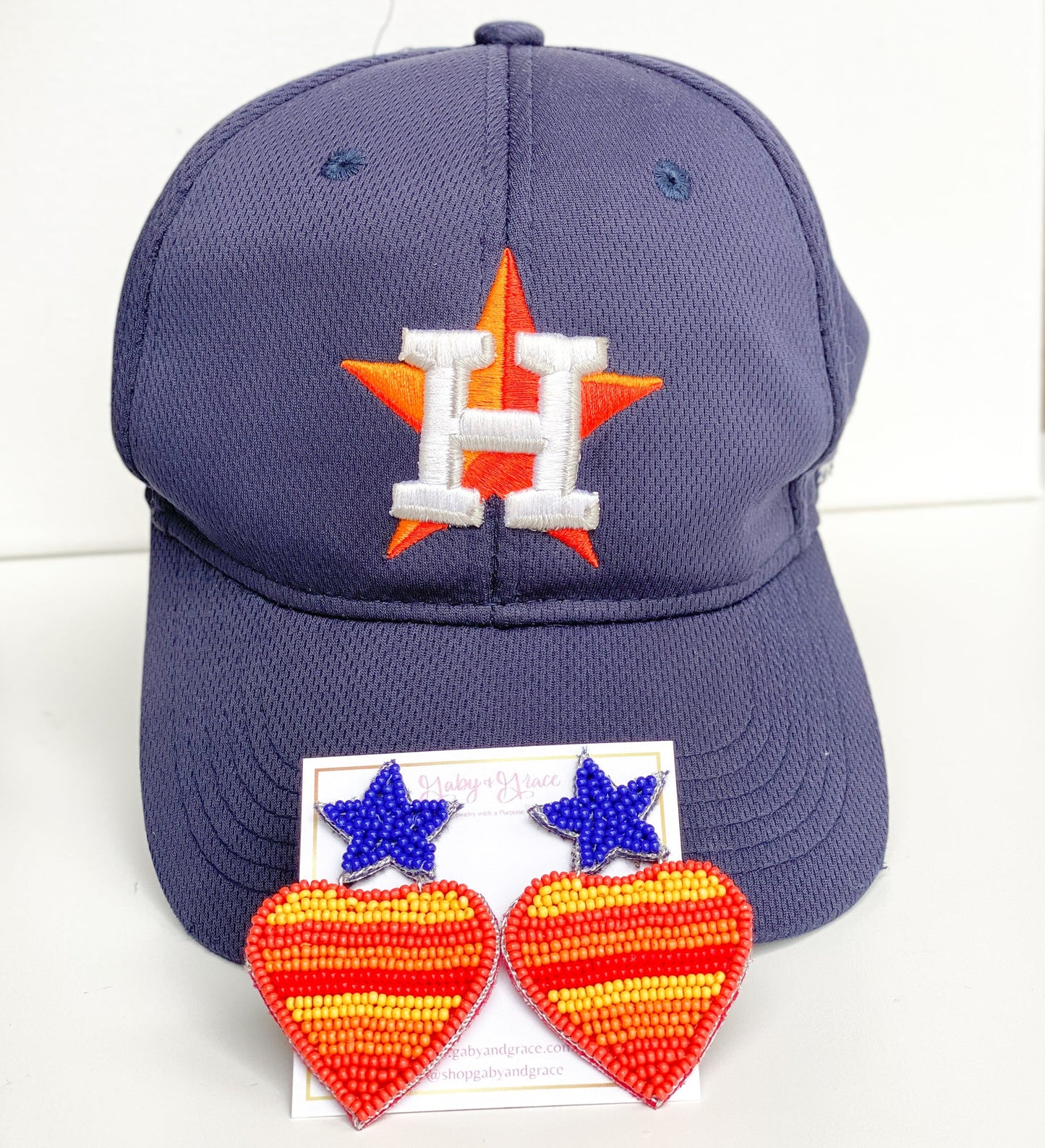 Go, Houston Astros! Cheer and show your love for the Astros baseball team in style with our custom design beaded Astros earrings in the shape of a heart with the Astros Vintage Colors and a blue star as a stud.