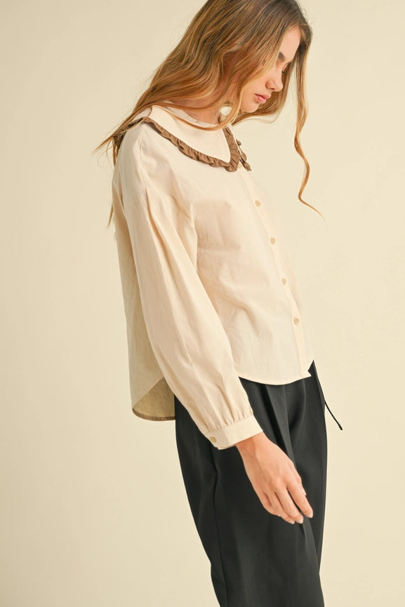Turn heads with this classic button-down top with shimmery, cuff details. Collar up your style game and make a statement! Plus, the long sleeves will keep you feeling warm and cozy, even in a chilly room. Cute AND comfy - it's a win-win!