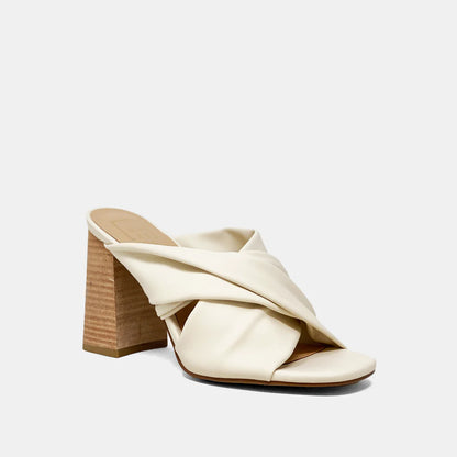 Crafted from soft faux leather, our FIJI slip-on sandal is a timeless silhouette updated with contemporary details, like its drpaed upper and stacked chunky heel. Wear yours with wide jeans or tailored pants.