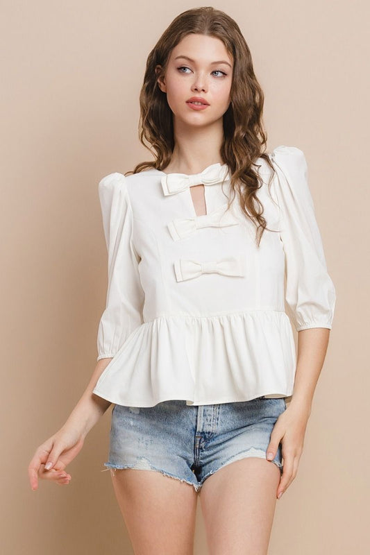 Say hello to the Hey Darling Top! This playful peplum top features darling 3/4" sleeves and a cute bow accent at the center. With a hidden zipper in the back, you'll never have to worry about fussy buttons. Perfect for adding a touch of charm to any outfit!