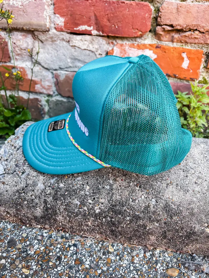 Teal trucker hat with "support day drinking" embroidery
