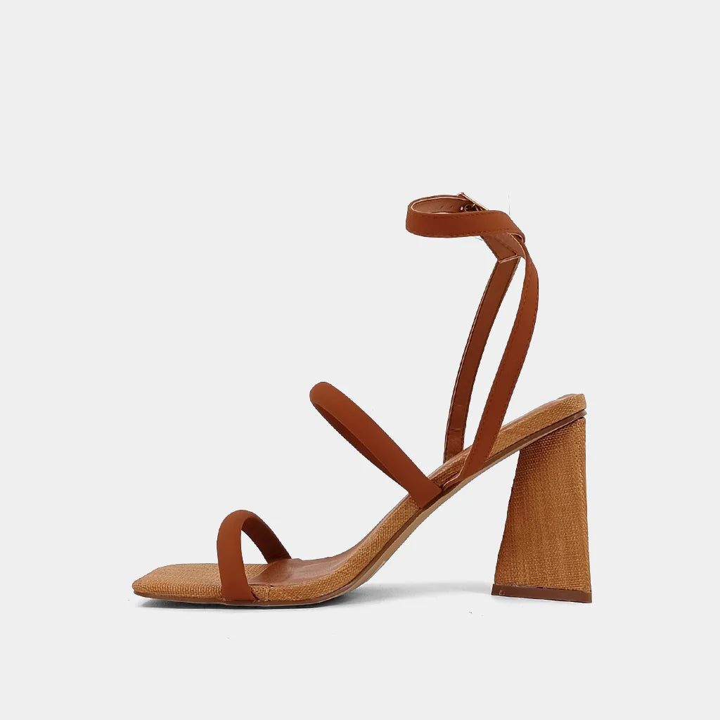 Crafted from luxurious faux leather with a stunning woven texture, supported by an eye-catching pyramid-shaped heel, and secured with an elegant ankle strap, EVANGELINE is the ultimate high-heel sandal to elevate any outfit, from flowing dresses to casual denim.