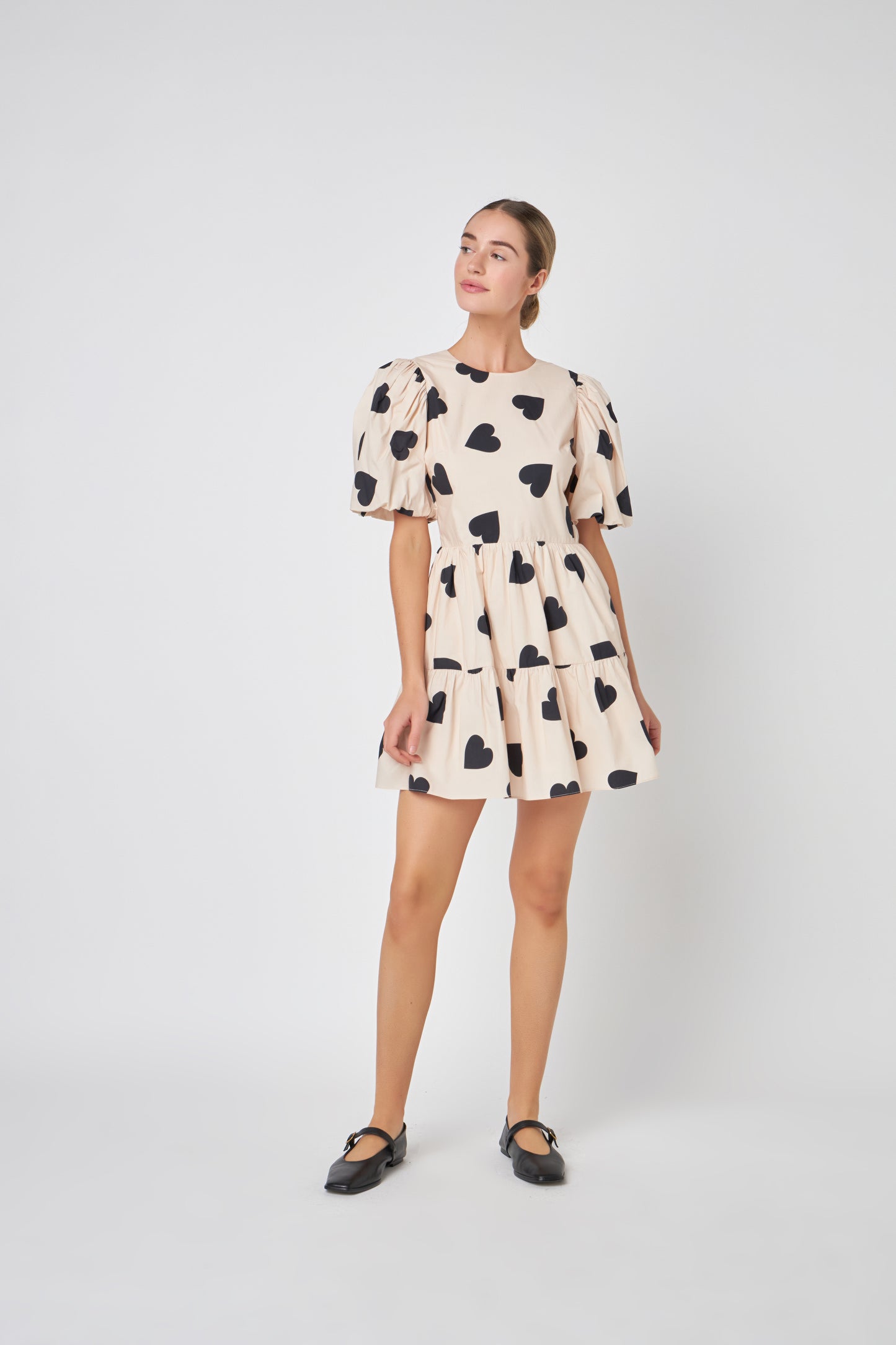 Be the showstopper with the 'I Heart You' Dress, a bold fashion statement, this dress is the ONE that will turn heads and is a perfect mix of sophistication and playfulness. With puff sleeves, a dreamy silhouette, and open back. The timeless ivory hue serves as a blank canvas for your individual style. It's versatile enough to showcase your personal accessories and pairings, making this dress a perfect canvas for self-expression. The attention to detail is evident in every stitch.