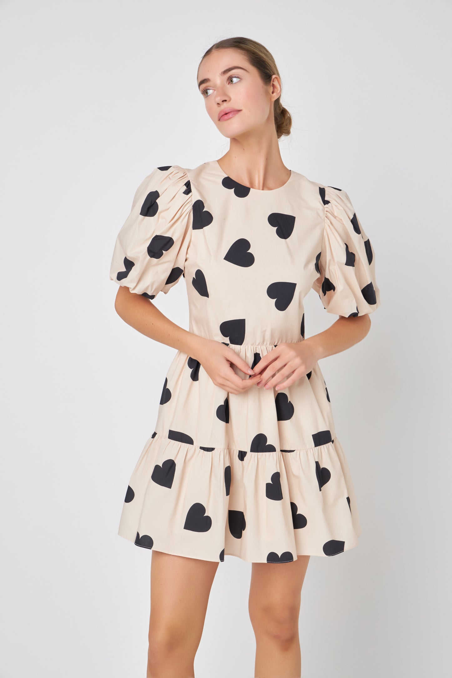 Be the showstopper with the 'I Heart You' Dress, a bold fashion statement, this dress is the ONE that will turn heads and is a perfect mix of sophistication and playfulness. With puff sleeves, a dreamy silhouette, and open back. The timeless ivory hue serves as a blank canvas for your individual style. It's versatile enough to showcase your personal accessories and pairings, making this dress a perfect canvas for self-expression. The attention to detail is evident in every stitch.