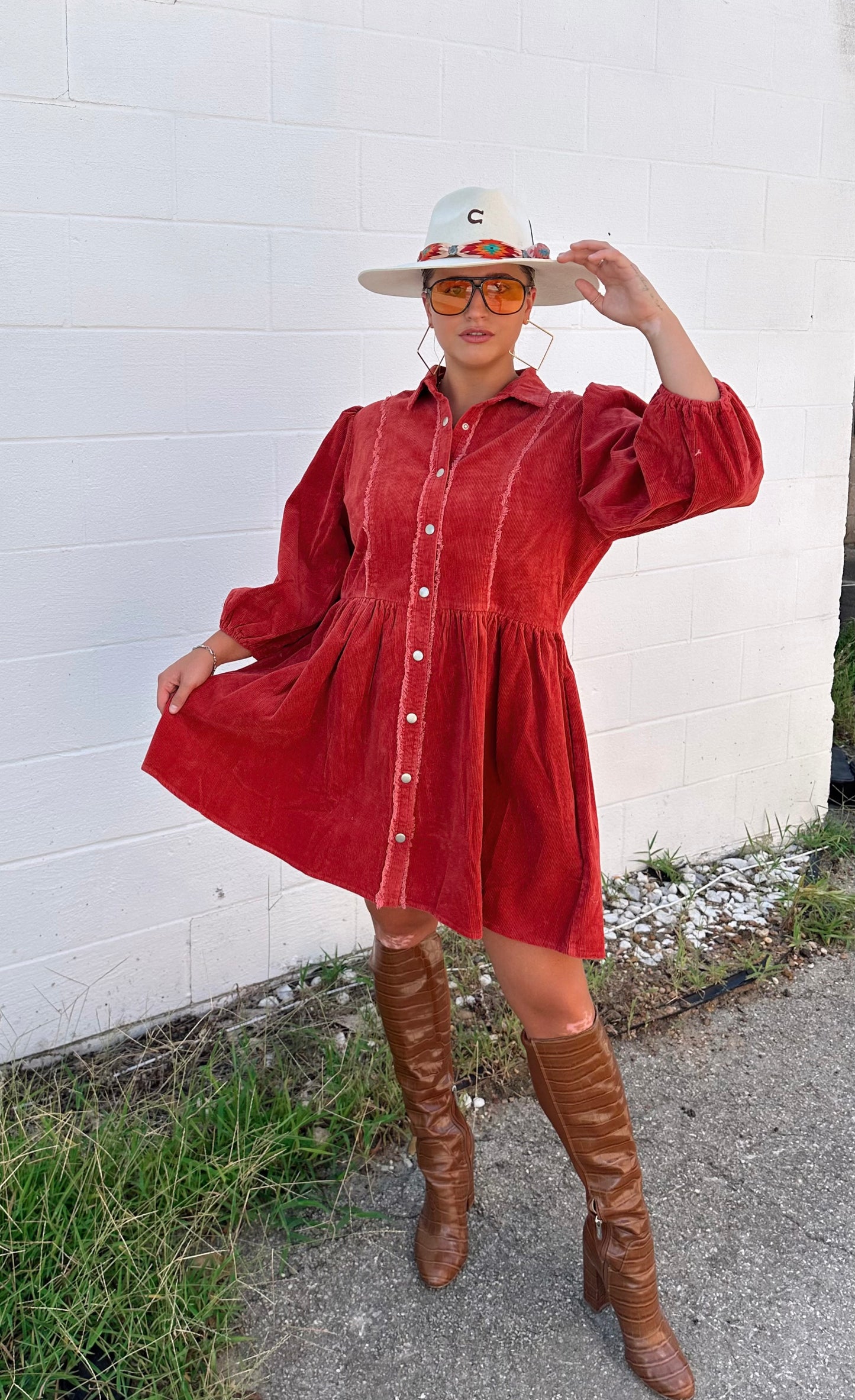 Corduroy babydoll mini dress, collared, half puff sleeves, button-down closure and pockets.