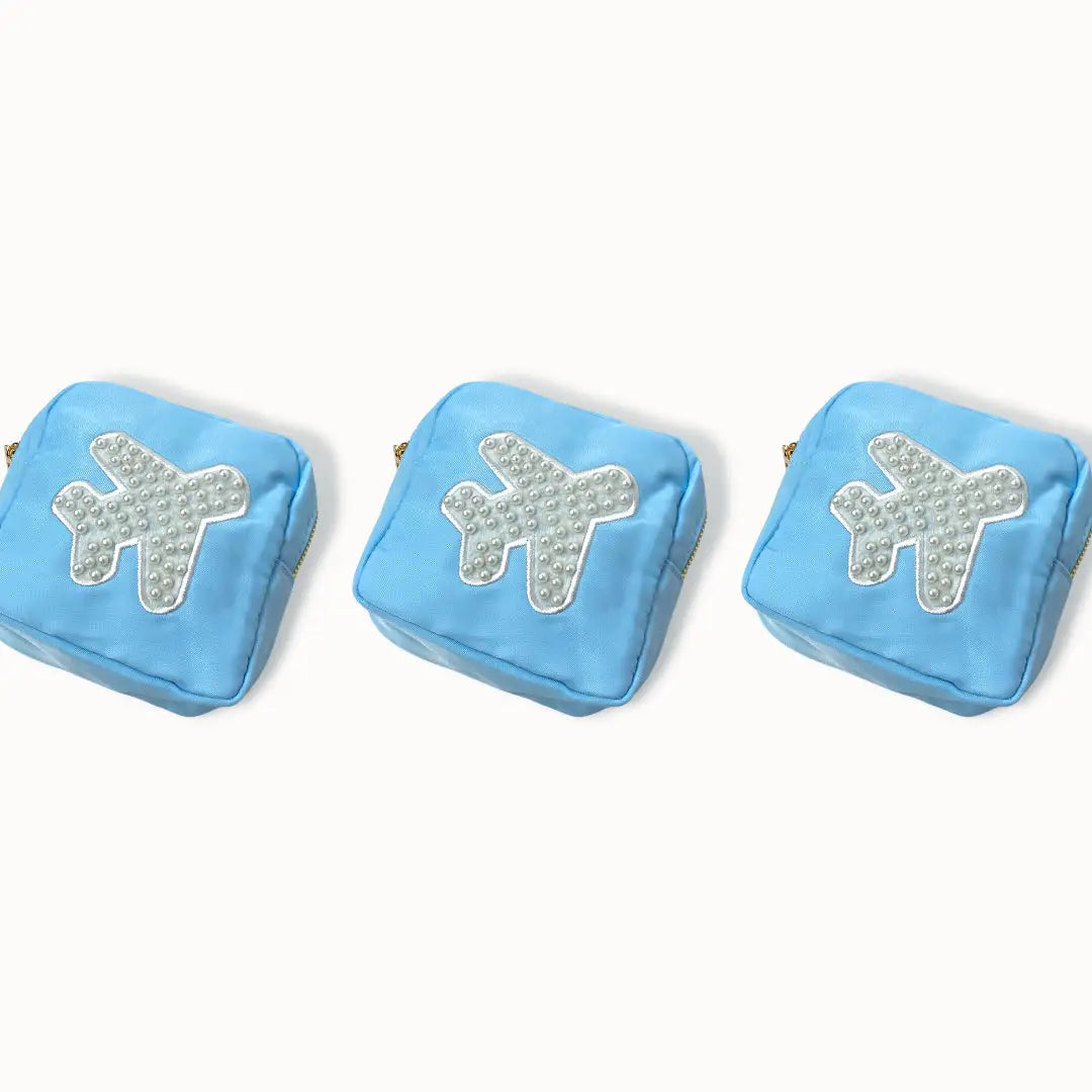 With their small compact size these minis are perfect for holding your on the go makeup collection, jewelry favs, or a throw all in your purse. Pair it with our any of our other medium, large, or xl makeup bags to create the dreamiest bathroom counter addition. Beaded Airplane patch is SEWN on.
