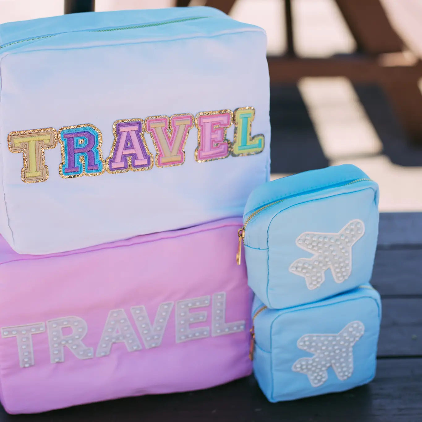 With their small compact size these minis are perfect for holding your on the go makeup collection, jewelry favs, or a throw all in your purse. Pair it with our any of our other medium, large, or xl makeup bags to create the dreamiest bathroom counter addition. Beaded Airplane patch is SEWN on.