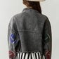 Elevate your game day style in our Game Day Jacket, a dazzling expression of team spirit. Rhinestone patches dazzle & catch the light, button-down closure ensures fit & layers. Pockets store essentials. Raw hem, cropped length adds edgy style. Perfect for a confident, fashion-forward look.