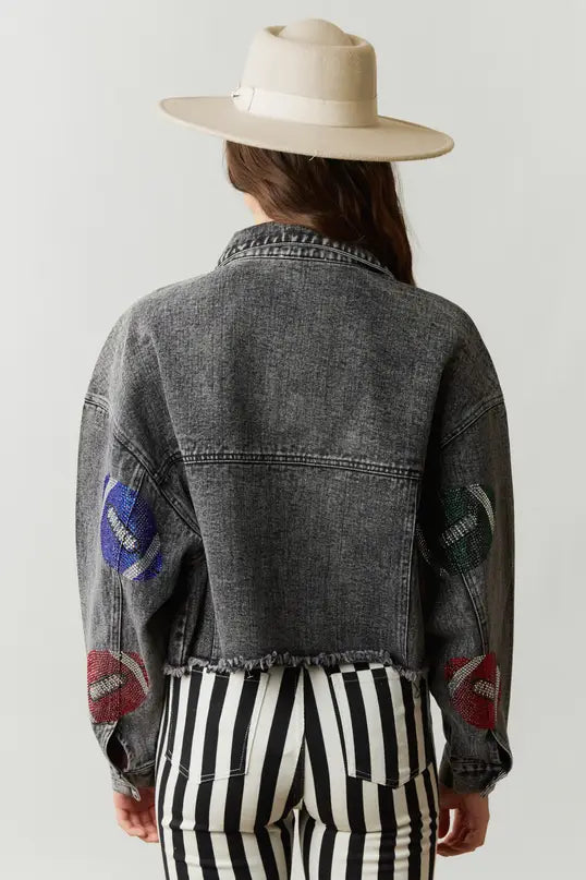 Elevate your game day style in our Game Day Jacket, a dazzling expression of team spirit. Rhinestone patches dazzle & catch the light, button-down closure ensures fit & layers. Pockets store essentials. Raw hem, cropped length adds edgy style. Perfect for a confident, fashion-forward look.