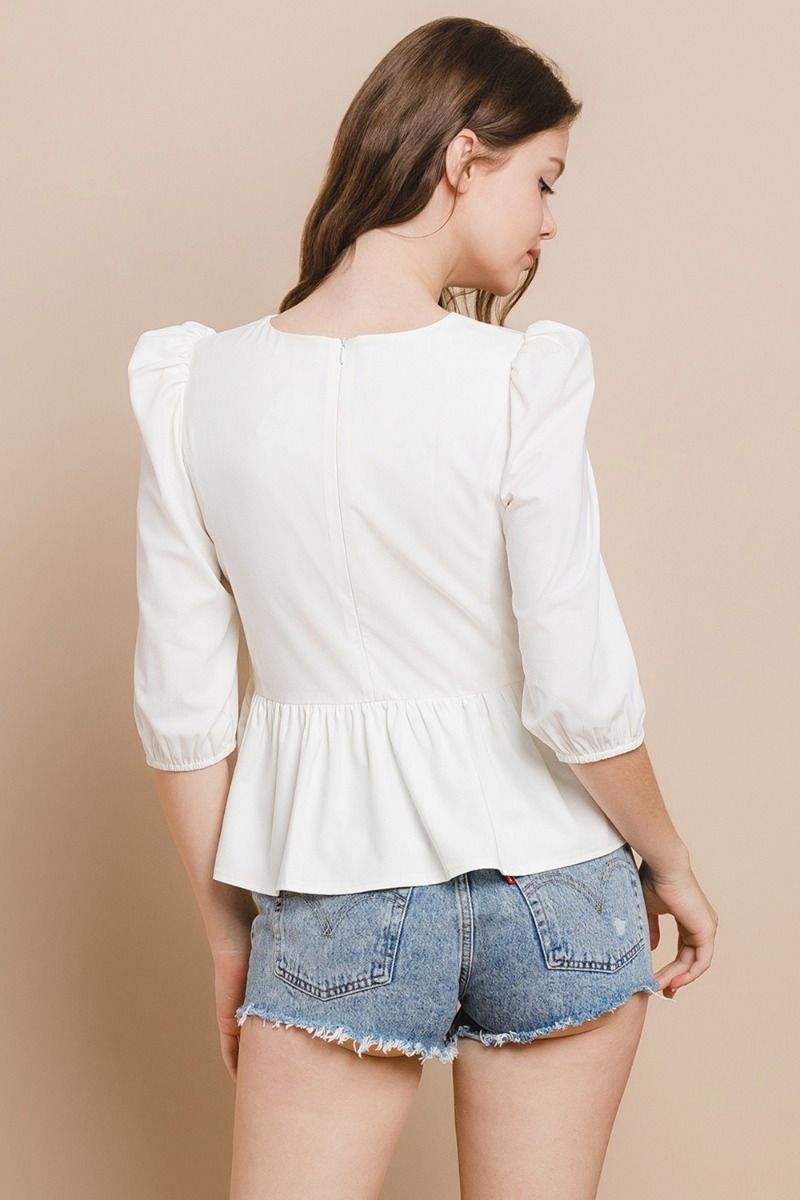 Say hello to the Hey Darling Top! This playful peplum top features darling 3/4" sleeves and a cute bow accent at the center. With a hidden zipper in the back, you'll never have to worry about fussy buttons. Perfect for adding a touch of charm to any outfit!