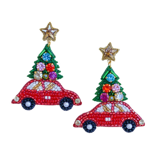 Celebrate the Holidays with these cute earrings representing the tradition of getting and carrying a Christmas tree on top of a car. These earrings feature so many details: the beaded fun red car, the Christmas tree filled with shimmery stones topped with a crystal star.  The craftsmanship on these Christmas earrings will captivate anyone!  Details: * Original Design * Handcrafted by artisans in India * Length 2.2" * Width 1.7"