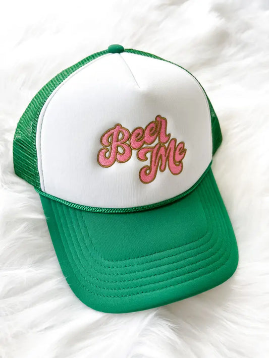 Green and white trucker hat. Embroidery design features 'beer me' in gold and pink.