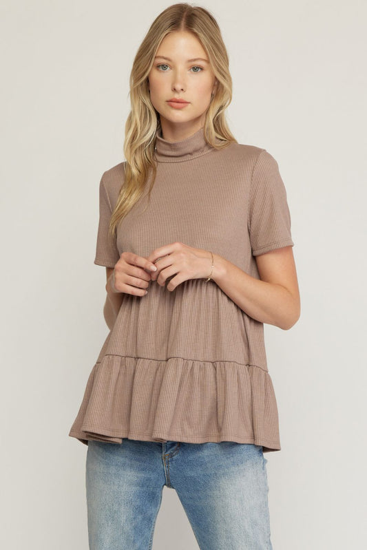 Show off your style in this sassy, lightweight tiered ribbed top with a mock neck and short sleeves. Flaunt your unique look while still keeping it comfy and chic! Pair with your favorite jeans, you can't go wrong!