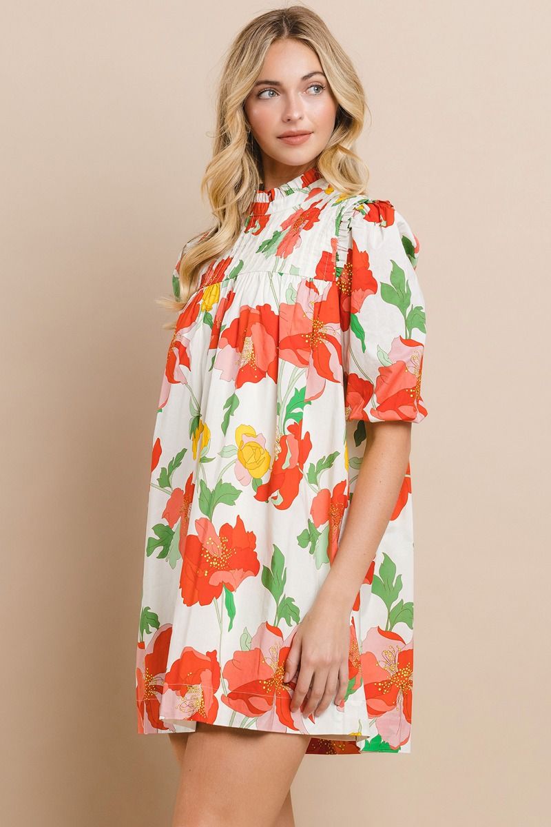 Make a statement with the playful and stylish Sunshine Forever Dress. This floral printed shift dress features a ruffled mock neck and pleated detailing, along with half puff sleeves and a back buttoned keyhole for added flair. Stay ahead of the fashion game with this must-have dress!