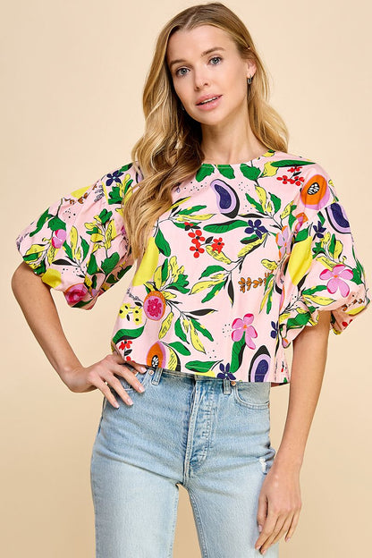 Introducing the Resort Cutie Top: a vibrant and playful addition to your wardrobe. This abstract printed top boasts short balloon sleeves and a flattering dropped shoulder design, perfect for any occasion. With a back keyhole and button closures, it's effortlessly stylish and easy to wear. Order yours today!