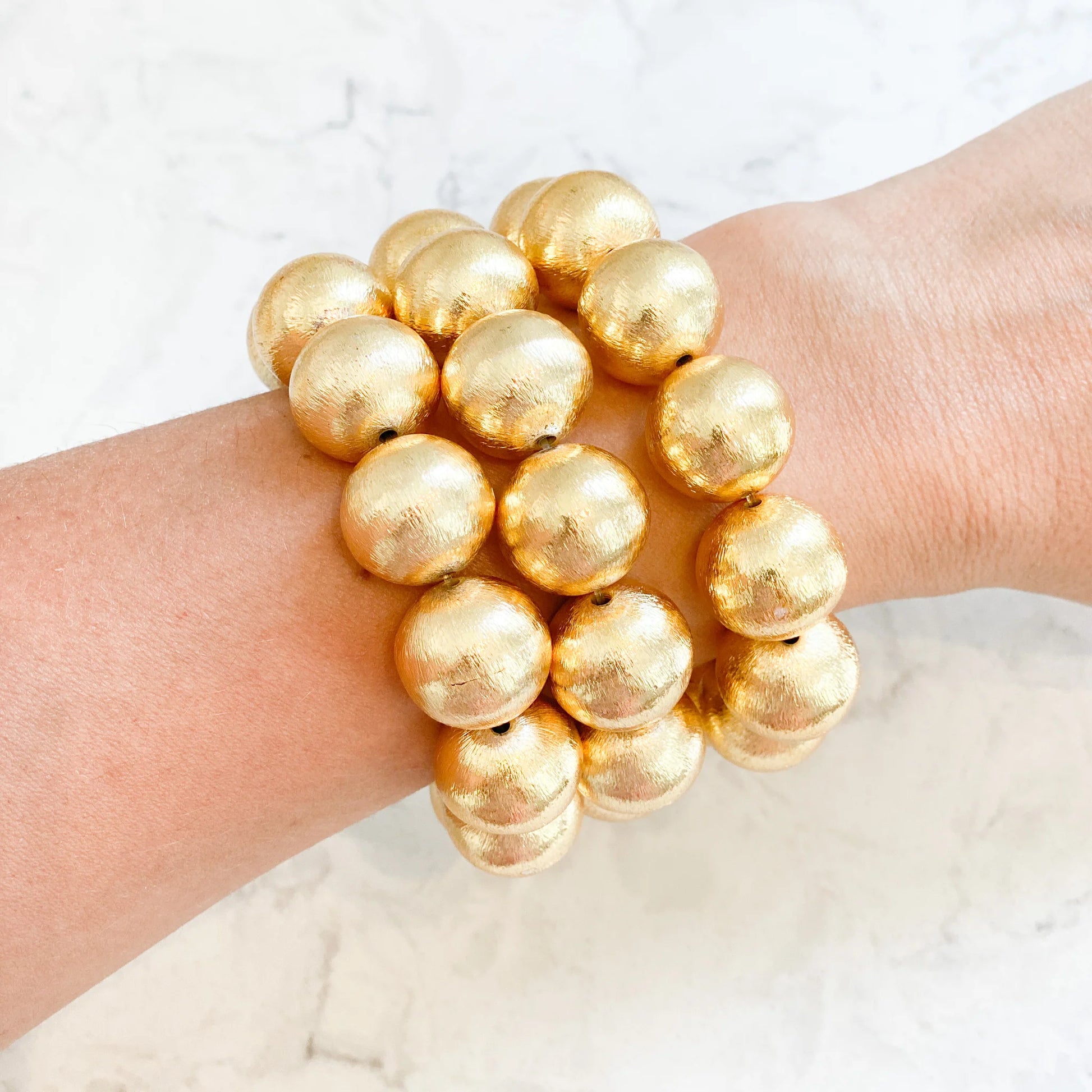Elevate any outfit with these beautiful bracelets! They are made with brushed gold-plated copper beads.  7" long Stretchy Elastic 16mm beads Looks great if you stack them!