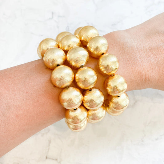 Elevate any outfit with these beautiful bracelets! They are made with brushed gold-plated copper beads.  7" long Stretchy Elastic 16mm beads Looks great if you stack them!
