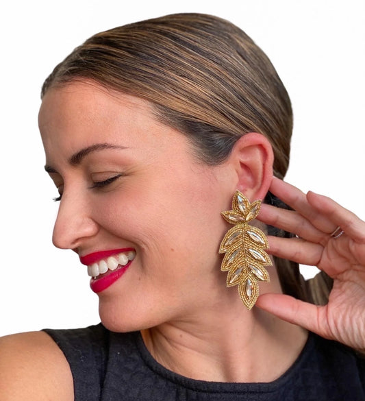 Our popular Lilly earrings make a gorgeous addition to any outfit, and now they're dressed in gold! With crystals and glass beads, these earrings will make you sparkle whether you wear them with your hair up or down. A must-have for parties, weddings, or just special occasions.