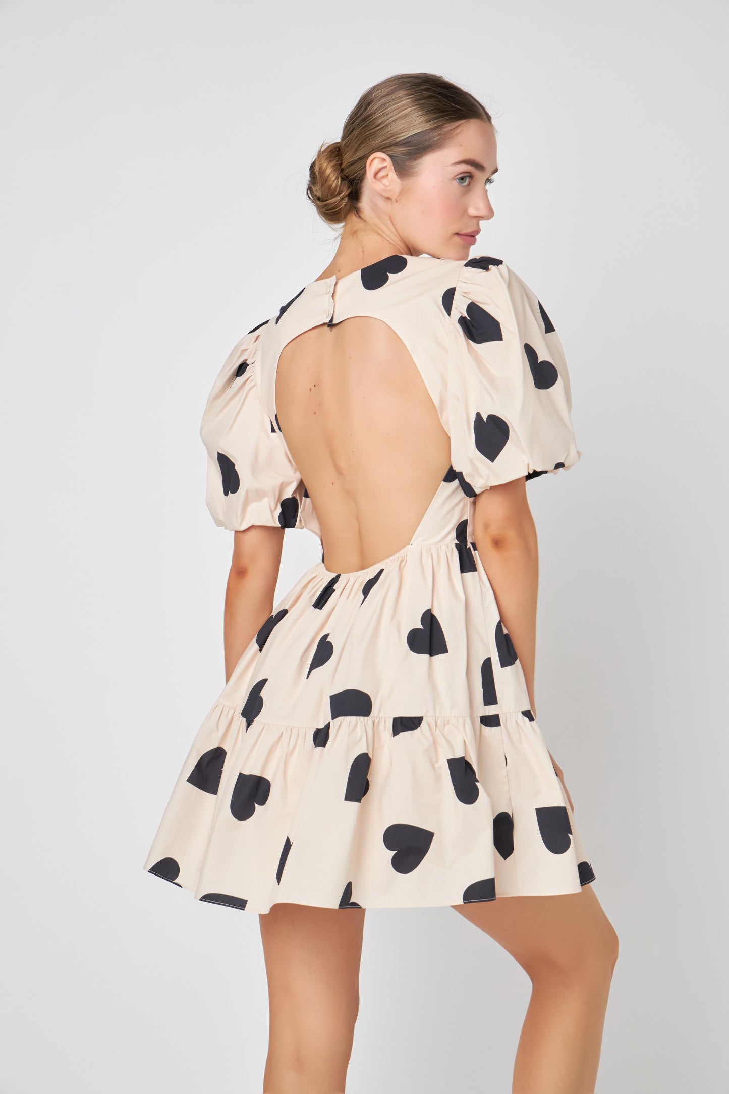 Be the showstopper with the 'I Heart You' Dress, a bold fashion statement, this dress is the ONE that will turn heads and is a perfect mix of sophistication and playfulness. With puff sleeves, a dreamy silhouette, and open back. The timeless ivory hue serves as a blank canvas for your individual style. It's versatile enough to showcase your personal accessories and pairings, making this dress a perfect canvas for self-expression. The attention to detail is evident in every stitch. 