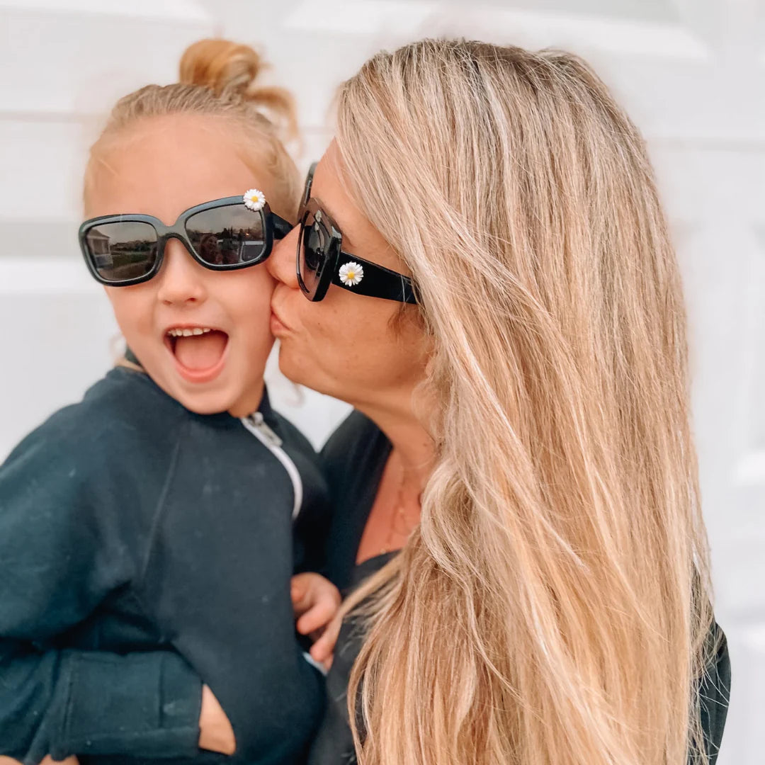 These glossy, black sunglasses feature polarized lenses and still very fashionable. Mommy and me! Make summer-time memories in style! With UV-protective lenses, you can rest assured that your little one's eyes are safe. Plus, they'll look oh-so-cute!