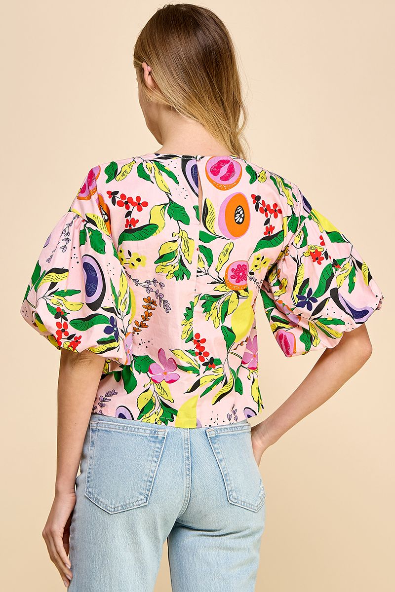 Introducing the Resort Cutie Top: a vibrant and playful addition to your wardrobe. This abstract printed top boasts short balloon sleeves and a flattering dropped shoulder design, perfect for any occasion. With a back keyhole and button closures, it's effortlessly stylish and easy to wear. Order yours today!