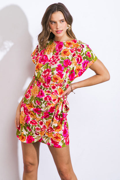 Get ready to turn heads in this printed woven mini dress! With its wide neckline and short sleeves, this dress is both stylish and comfortable. The side tie overlay adds a unique touch, while the back bodice slit and skirt zipper closure make it easy to wear. Make a fashion statement with this one-of-a-kind dress!