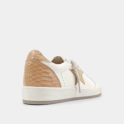 PAZ is one of our favorite must-have retro sneaker, with a low top upper body crafted in faux leather, synthetic snakeskin and glitter in contrasting white and taupe accents. These look amazing paired with shorts, cropped jeans and dresses.