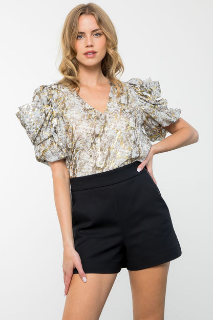 Add some sizzle to your wardrobe with this head-turning top! With an eye-catching snake print and sparkling accents, this fun and flirty ruffled top will turn heads. Shine bright with the Bring the Sparkle Top! - THML