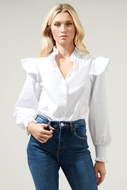 Add this classic poplin blouse to your wardrobe. An easy-to-style top that features a ruffle mock neckline with a button front. Ruffle cap shoulder details top a balloon sleeve with a smocked cuff. Wear this crisp, cool top tucked into high rise denim for an effortless look.