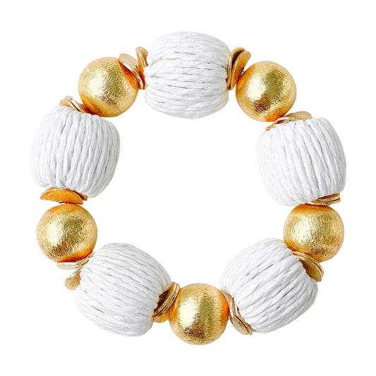 Elevate any outfit with these beautiful bracelets! They are made out of brushed gold plated copper beads and hand wrapped raffia beads.  7" long  Stretchy Elastic  14mm beads  Look great if you stack them!