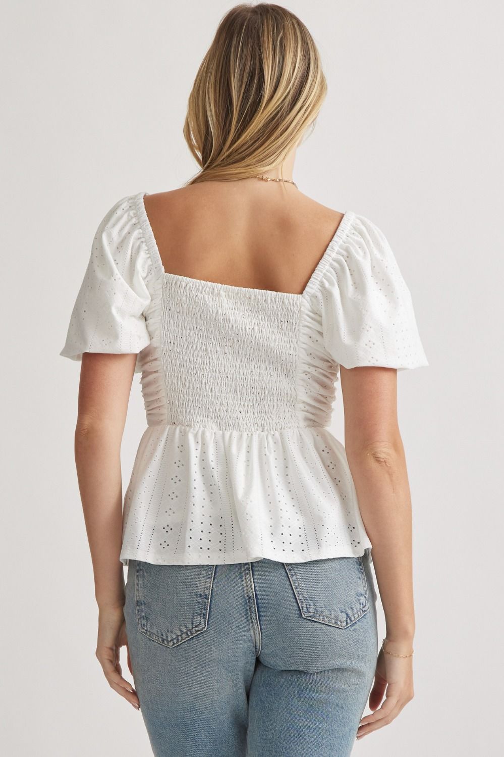 Elevate your wardrobe with our Springtime Sip Top! This eyelet sweetheart neckline top features delicate puff sleeves and ruching at the front, giving it a romantic and elegant look. The smocked back and lining provide a comfortable, flattering fit. Made with high-quality woven fabric, this top is non-sheer and perfect for any occasion. Transform your outfit with this must-have piece!