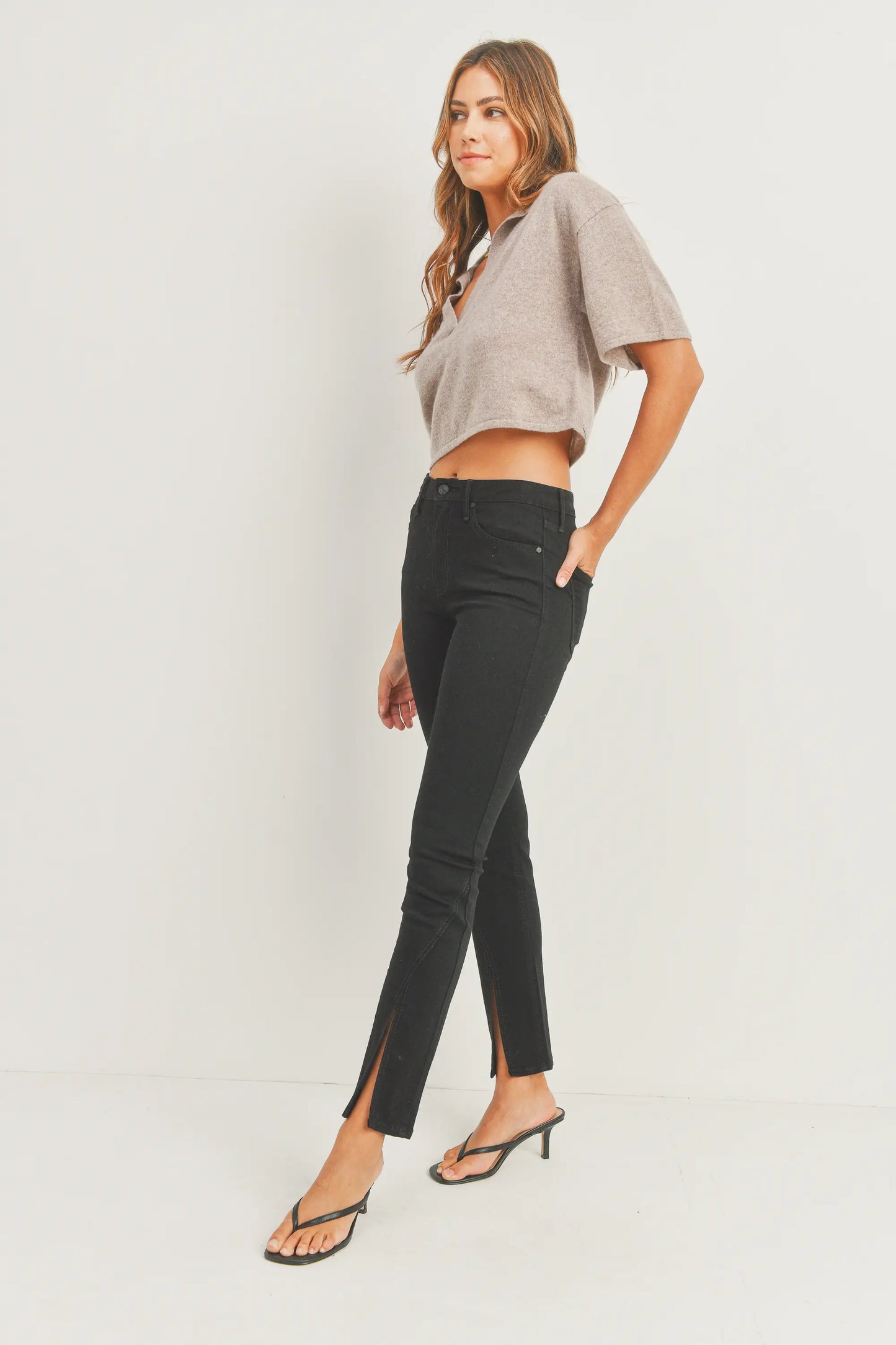 Elevate your denim game with the JUST BLACK DENIM Mid Rise - Split Hem Slim Jeans. The mid rise design offers a flattering fit that sits comfortably on your hips, creating a sleek and modern silhouette that effortlessly complements your shape. 10.5" rise and a 30" inseam. The 7" split hem adds a dash of flair and timeless appeal. Pair these jeans with your favorite heels for an elevated look, or embrace a more laid-back vibe with sneakers or ankle boots. 