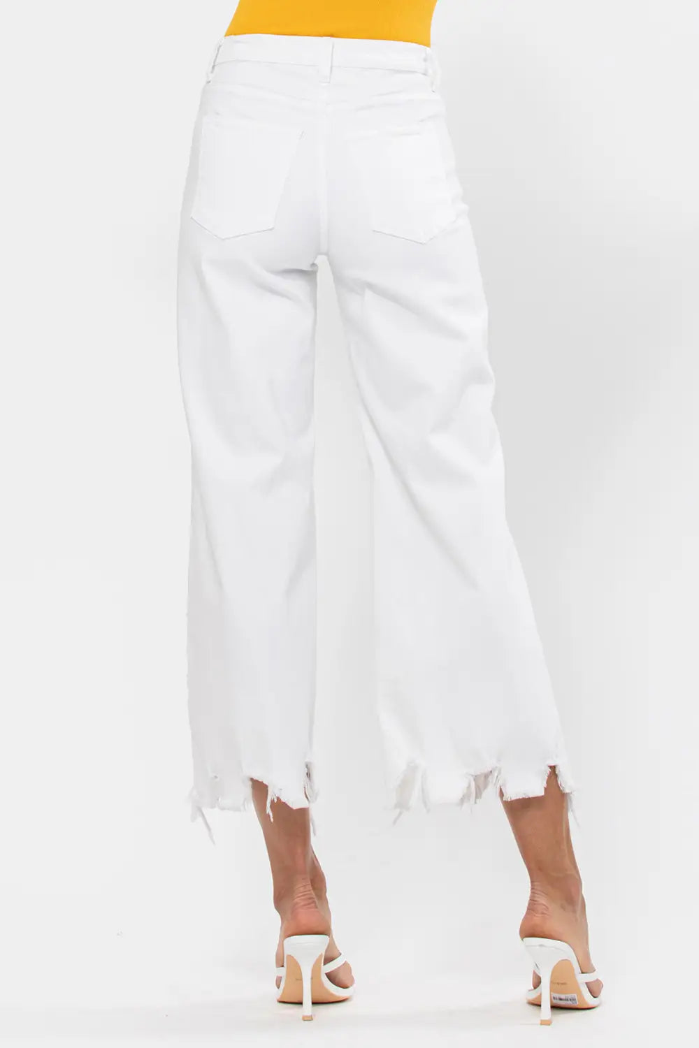 The 'New Beginnings' High Rise Cropped Wide Leg Jeans. High rise design offers a fit that flatters your figure and elongates your legs. Cropped jeans with a wide leg is perfect for showcasing your favorite footwear – from heels to sneakers. Make a bold statement with the destroyed open knees and frayed hem that add an edgy vibe to your ensemble.  22" front rise, 10 1/2" inseam, and 26" knee. Express yourself by pairing them with your favorite tops, accessories, and footwear.