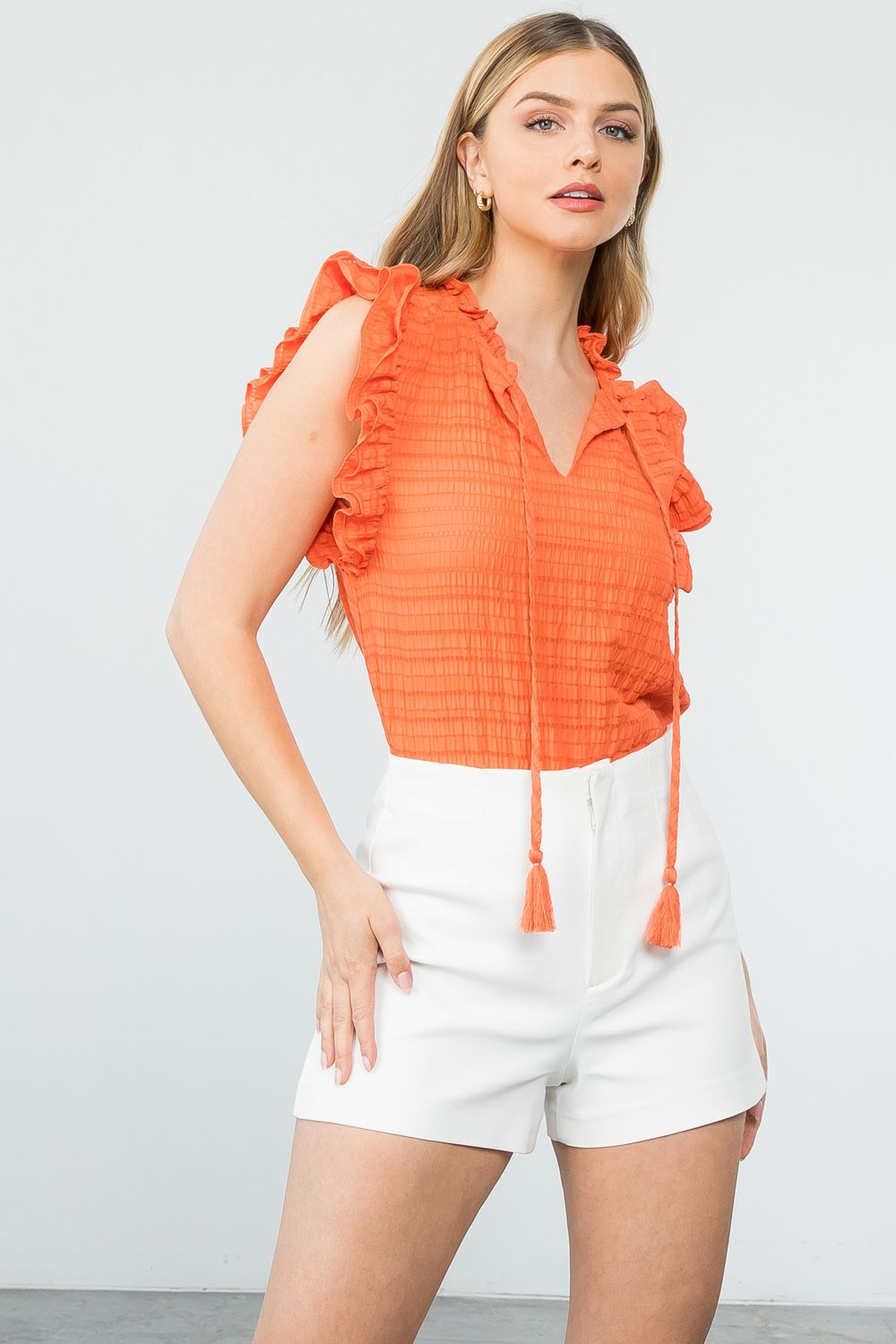Sun and Sand Top. Everyday kind of top! Smocked, ties in front with ruffle sleeves. Adorable orange top