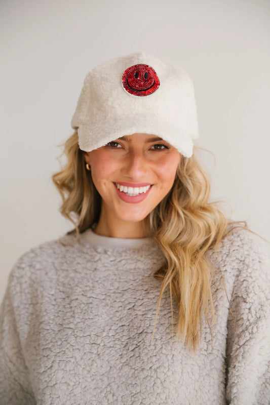 Red glitter smiley cap on an sherpa adjustable ball cap.  One size fits all. 