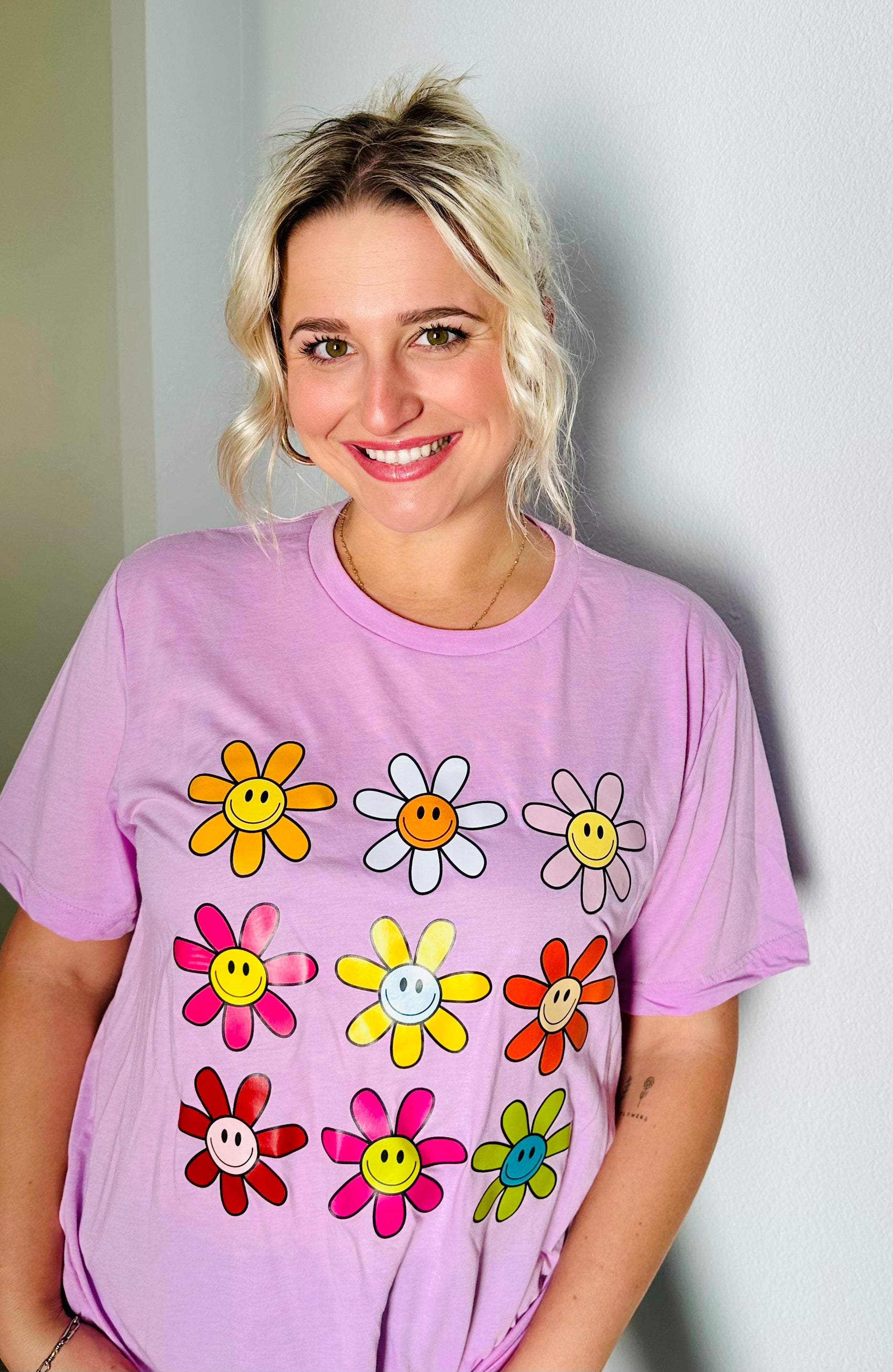 Be the ray of sunshine with the Bright Flower Smiley Face Tri-Blend Extra Soft Short Sleeve Tee. This shirt creates a unique and joyful expression of fashion.  Adorned with an array of vibrant flowers, each bearing a cheerful smiley face, this tee is a visual delight. Crafted from a premium tri-blend fabric, our tee envelops you in a cocoon of softness that's gentle on your skin, ensuring you feel comfortable and confident wherever you go.